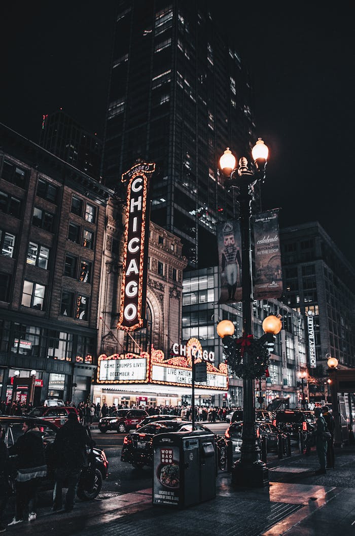 Captivating nighttime view of Chicago Theatre illuminated with city lights and bustling traffic.